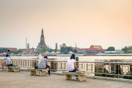 Bangkok - February 8: Undefined tourist relax at Tha Tien Pier with Wat Arun and Chao Pra Ya River background on February 8, 2015 at Bangkok Thailand.のeditorial素材