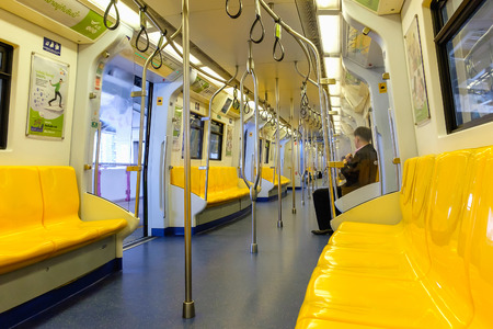 Bangkok, Thailand - June 18, 2016: Overview of yellow seats in electric train, Public Transportation in Bangkok. Sky train / BTS elevated railsのeditorial素材