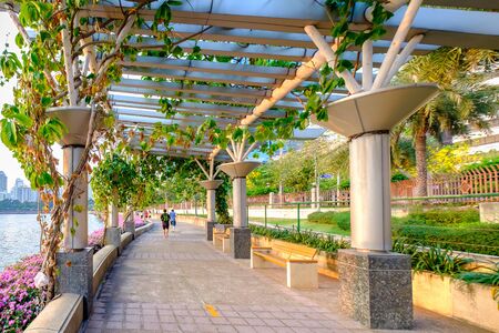Bangkok, Thailand - April 25, 2016: Men are running in Benjakitti park, Bangkok downtown city at dusk on April 25, 2016.のeditorial素材
