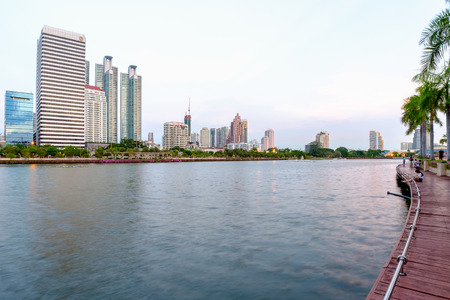 Bangkok, Thailand - June 6, 2016: Cityscape, office buildings and apartments in Thailand at dusk. View from public park.のeditorial素材