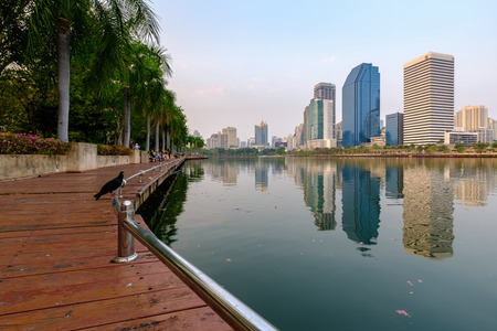 Bangkok, Thailand - February 10, 2017: Benjakitti park, Bangkok downtown city in the evening with skyline reflection.のeditorial素材