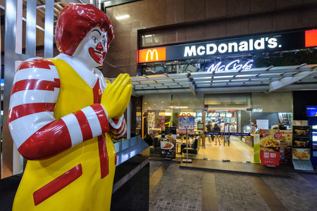 Bangkok, Thailand - July 25, 2017: McDonald's restaurant (Sathorn Nakorn) at night. McDonald's primarily sells hamburgers, cheeseburgers, chicken, french fries, breakfast items, soft drinks, milkshakes, dessertsのeditorial素材