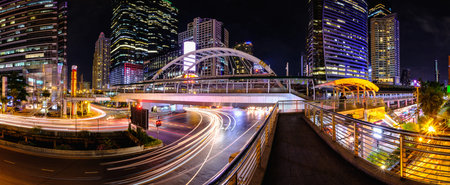 Panorama of Chong Nonsi Bangkok Sky Train Station Public Skywalk Bridge with the modern buildings on...