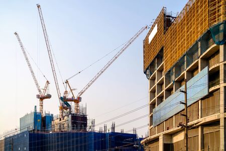 Construction site and sunset, structural steel beam build large residential buildings at construction siteの写真素材