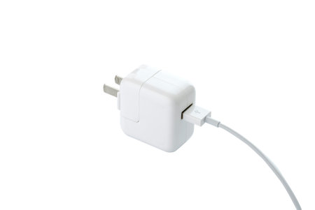 Close-Up a white plug adaptor for a USB cable for charge power.の写真素材