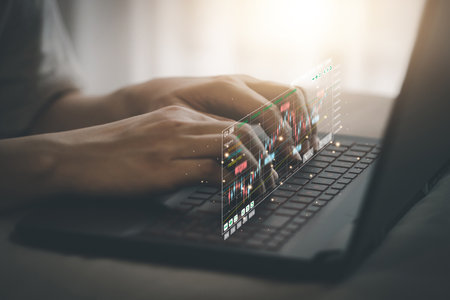 Man using Laptop PC to check the stock chart Financial business planning, investment, funds, digital asset trading and financial analysis in stock charts. Financial and investment Concept.の写真素材