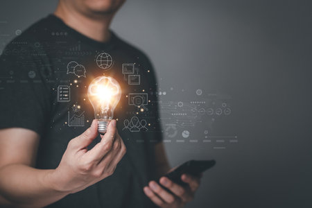 Men hold a light bulb and light up the light connecting the Internet around the world. Global Internet access plan for enterprises and digital markets, finance, banking and economy. Exchange big data.の写真素材