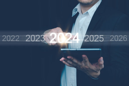 Man hand touch on a virtual screen. Future planning new year calendar, Businessman touching future growth year 2023 to 2024, Business strategy. Sort by year.の写真素材