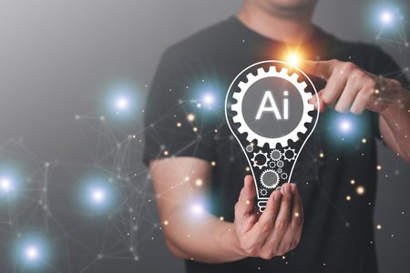 A man holding a lightbulb with the word AI on it.の写真素材