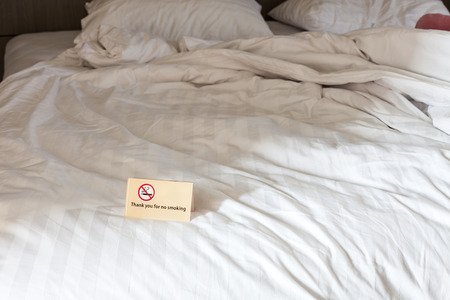 Thank you for no smoking Sign on the bed in hotel roomの写真素材