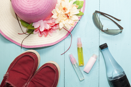 Top view of traveler's outfits,Summer holiday background, Beach accessories on wood backgroundの写真素材