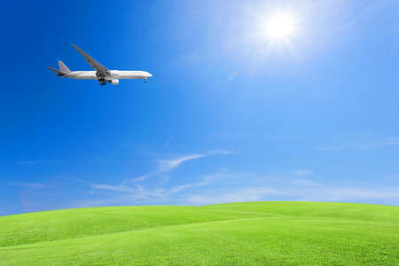 Green grass field with airplane ,blue sky and cloud backgroundの写真素材