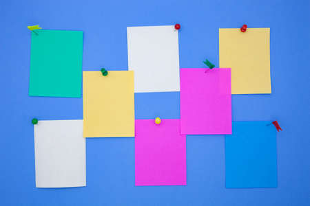 Colorful stick note papers on blue backgroundの写真素材