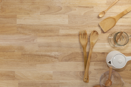 wooden spoon  with empty measuring cup and glass bottle on wood backgroundの写真素材