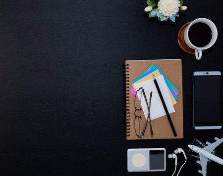 Office black leather desk table with smartphone, supplies and coffee cup ,office accessory, Top view...