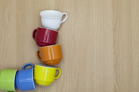 Colorful coffee cup on wood backgroundの写真素材