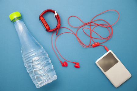 close up of water bottle,watch and red earphones on blue paper background,fitness background conceptの写真素材