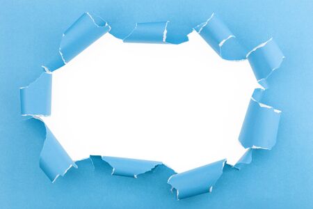 Ripped blue paper on white background with space for textの写真素材