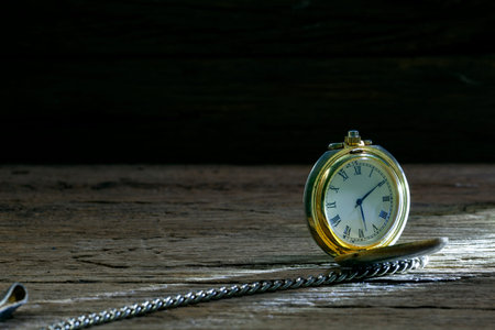 vintage pocket watch on old wooden background