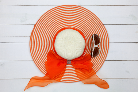 Top view with Beautiful summer hat and sunglasses on white wooden background,flat lay styleの写真素材