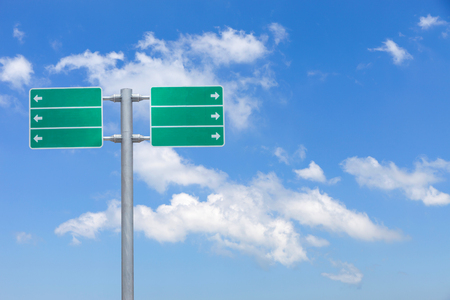 Blank green traffic road sign on sky backgroundの写真素材