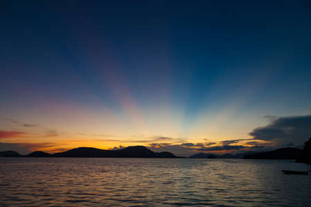 Beautiful colorful color and light sunset over tropical sea with reflectionの写真素材