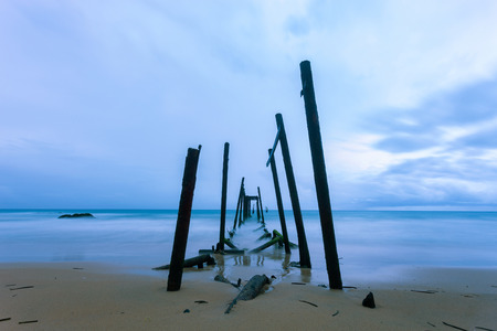 old wooden bridge to the sea in bad weather dayの写真素材