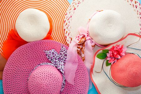 Beautiful set of summer hats on blue wooden background,flat lay styleの写真素材