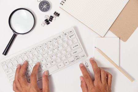 male hands use computer mouse and keyboard with business objects business workplace on office table,image for business background and designの写真素材