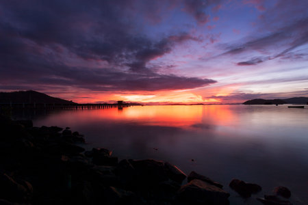 scenery view of old jetty to the sea beautiful sunrise or sunset in phuket thailandの写真素材