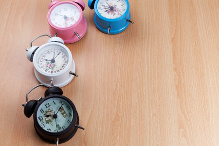 beautiful new classic alarm clock on wooden backgroundの写真素材
