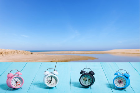 beautiful set of new classic alarm clock on blue wooden plank 
