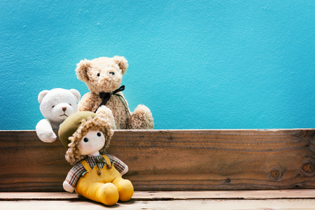 teddy bear on old wood ,blue wall backgroundの写真素材
