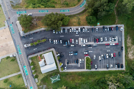 Aerial view drone shot of parking lot outdoors vehicles in the park