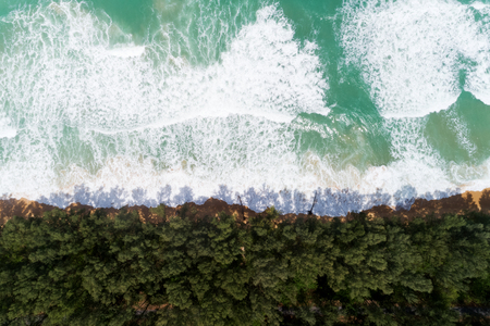 Tropical sea with wave crashing on beach aerial view drone shotの写真素材