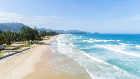 Beautiful wave crashing on sandy shore at karon beach in phuket thailand,aerial view drone shotの写真素材
