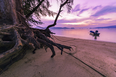 Long exposure image of dramatic sunset or sunrise,sky clouds over tropical sea with fishing boats in the seaの写真素材
