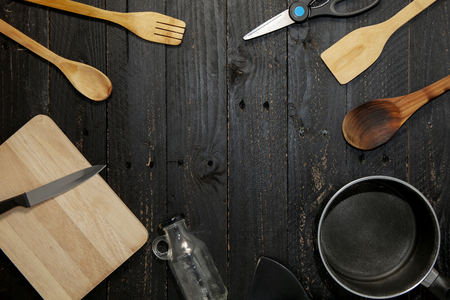 Set of kitchenware on the black wooden background.の写真素材