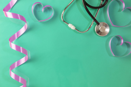 World health day background,Stethoscope and pink ribbon heart on green background,Concept healthcare and medical background.の写真素材