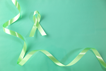 Green ribbon for Lymphoma Cancer background and mental health awareness background.の写真素材