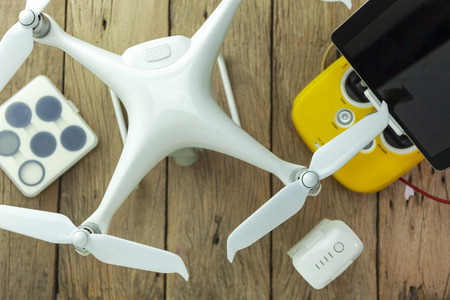 Drone equipment with Remote control on wood background flat lay composition.の写真素材