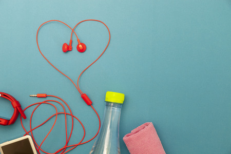 close up of water bottle,watch and red earphones Heart symbol on paper background,fitness background concept.の写真素材
