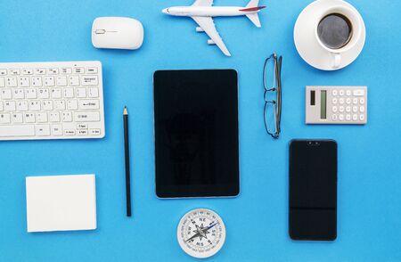 Top view of Office desk table of Business workplace and business objects on blue background.の写真素材
