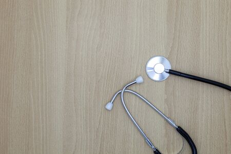 Stethoscope on wood background, medical background concept.の写真素材