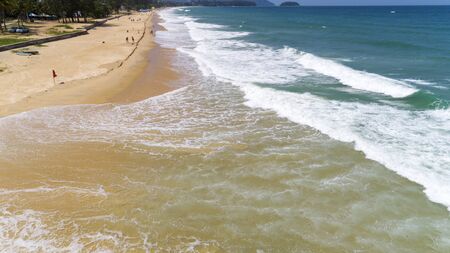 Beautiful tropical sea and wave crashing on sandy shore at karon beach in phuket thailand,aerial view drone shot.の写真素材