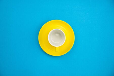 Colorful coffee cup on blue paper background.の写真素材