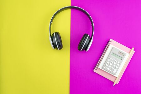 Headphone with Business paper note,pencil and business objects on colorful paper background.の写真素材