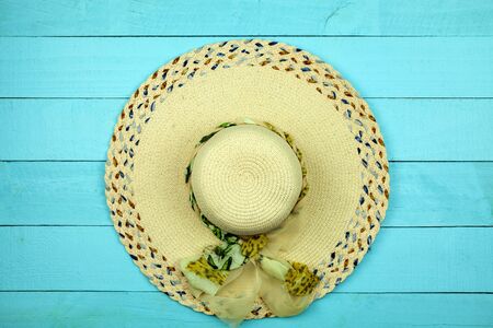 Beautiful lady hat beach on blue wood background.の写真素材