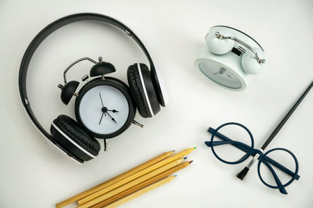 Teacher day concept Background of Glasses teacher,alarm clock,headphone and paint brush on white...