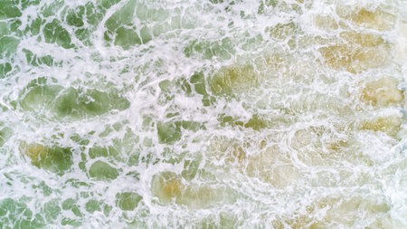 Top view nature landscape of Flowing wave white seafoam turquoise waves Beautiful tropical sea in...